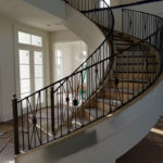 Large Curved Staircase Railing and Matching Balcony Rails
